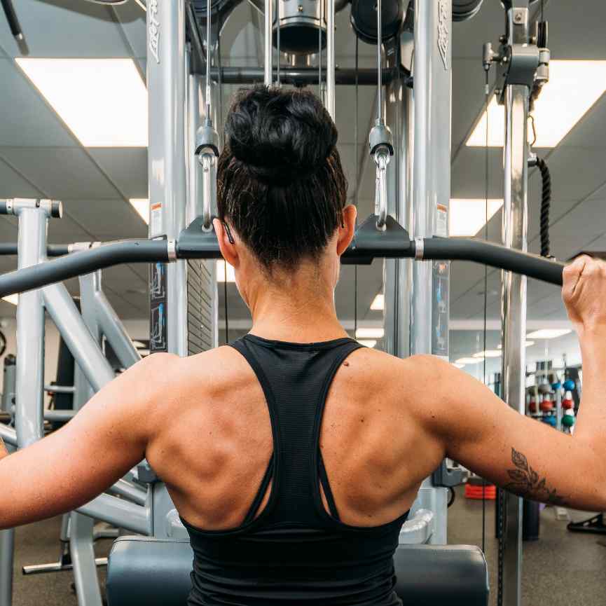Woman using lateral pull down machine
