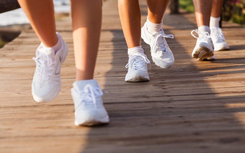 People wearing white sneakers, running