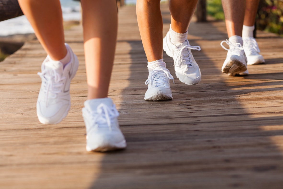 People wearing white sneakers, running