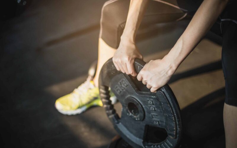 Woman holding barbell plate